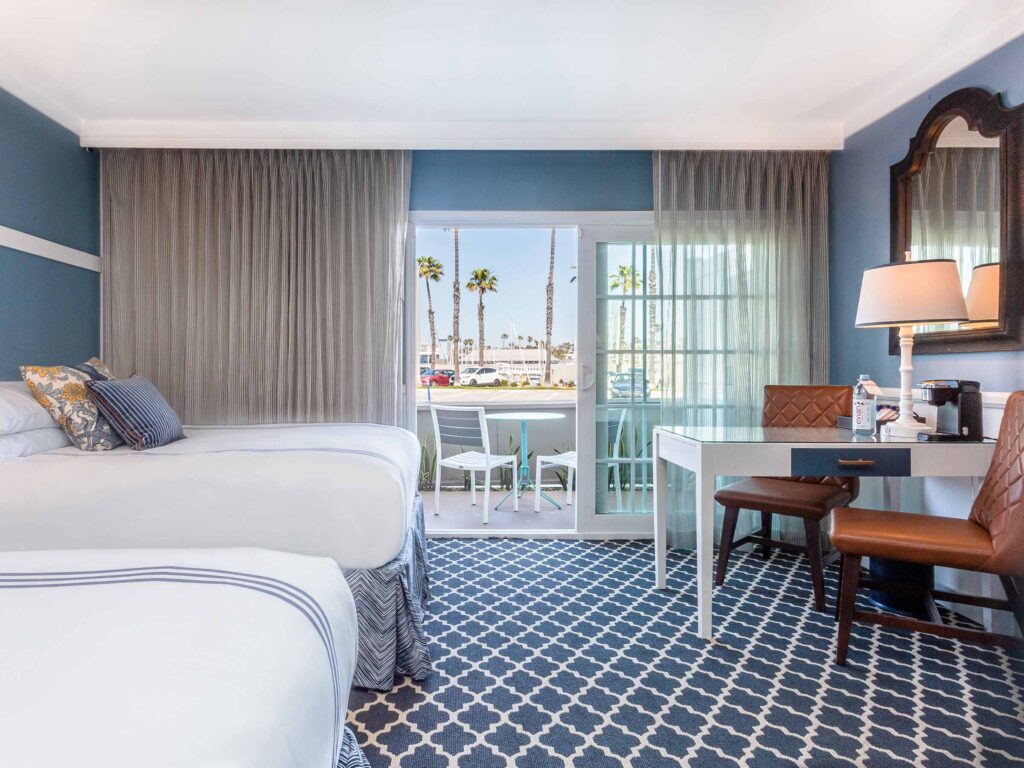 Guestroom With Two Beds And A Patio At Portofino Hotel